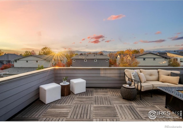 deck at dusk with an outdoor living space