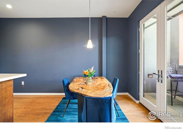 dining area featuring light hardwood / wood-style floors and french doors