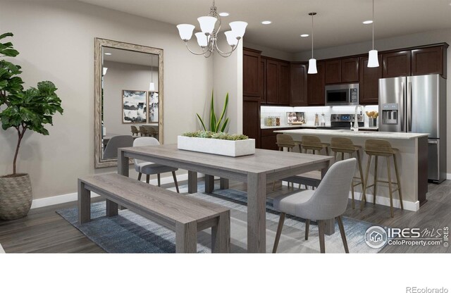 410 High Point Dr Unit 104, Longmont, CO 80504 - dining space featuring dark wood-type flooring, sink, and a chandelier