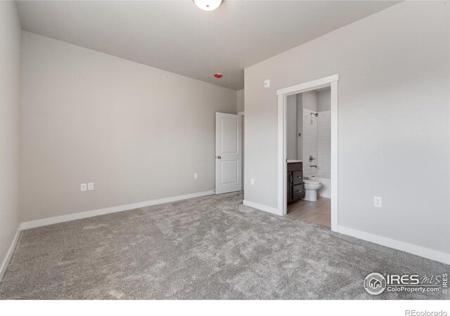 410 High Point Dr Unit 104, Longmont, CO 80504 - unfurnished bedroom featuring light colored carpet and ensuite bathroom