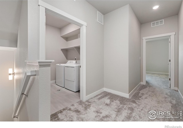 410 High Point Dr Unit 104, Longmont, CO 80504 - washroom with light colored carpet and washer and dryer