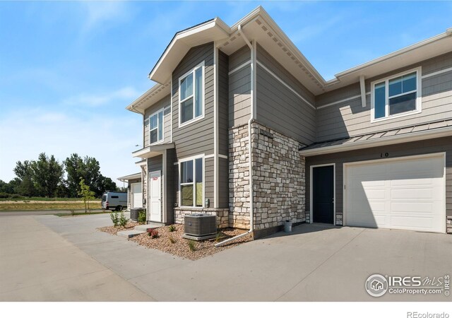 410 High Point Dr Unit 104, Longmont, CO 80504 - exterior space featuring a garage and central AC unit