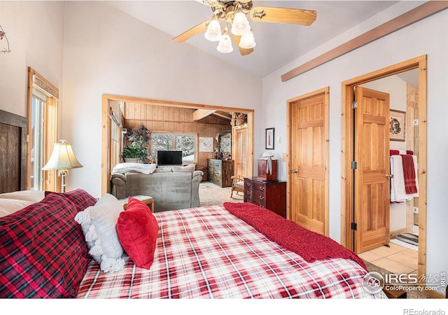 tiled bedroom with ceiling fan and lofted ceiling