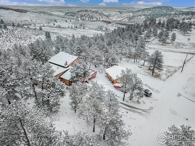 snowy aerial view featuring a mountain view