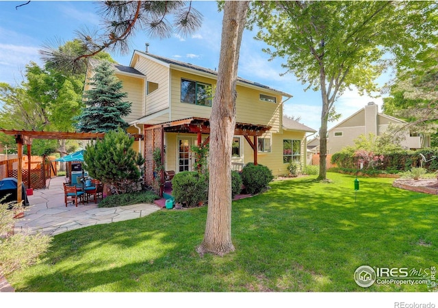 back of house with a pergola, a yard, and a patio