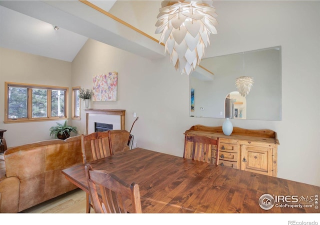 dining area with light hardwood / wood-style flooring and lofted ceiling