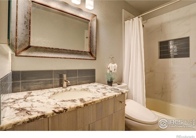 full bathroom featuring vanity, shower / tub combo, and toilet