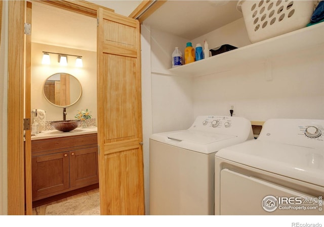 laundry room with washing machine and dryer and sink