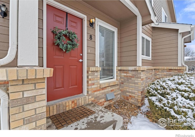 view of snow covered property entrance