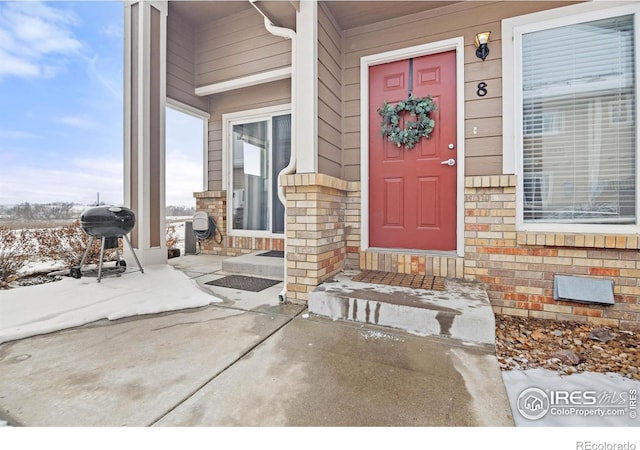 view of snow covered property entrance