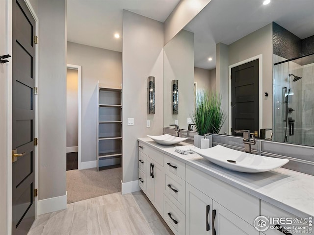 bathroom featuring vanity and a shower with shower door