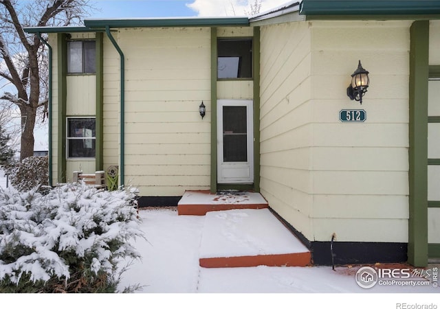 view of snow covered property entrance