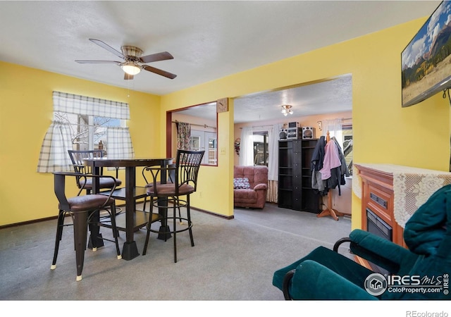 carpeted dining area featuring ceiling fan