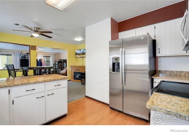 kitchen featuring white cabinetry, stainless steel fridge with ice dispenser, light hardwood / wood-style flooring, and ceiling fan