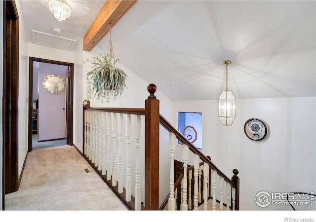 hall featuring beamed ceiling and light carpet