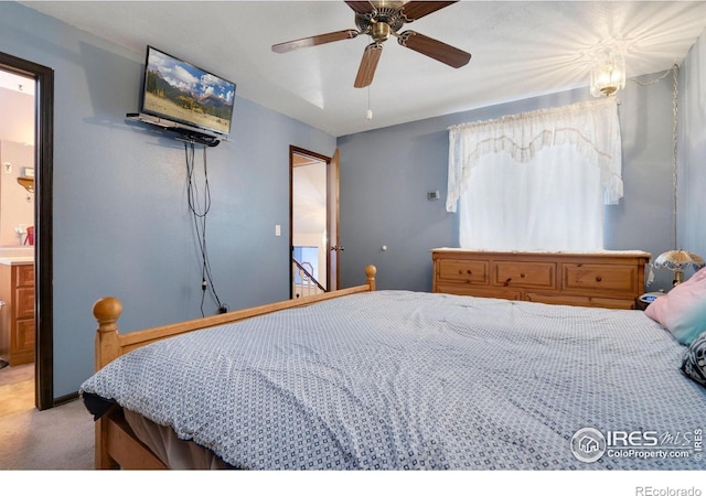 bedroom featuring carpet, ensuite bathroom, and ceiling fan