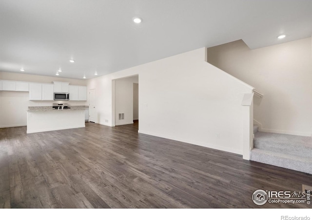 unfurnished living room with dark hardwood / wood-style flooring