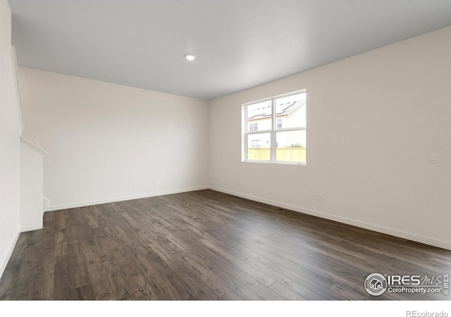 unfurnished room featuring dark hardwood / wood-style floors