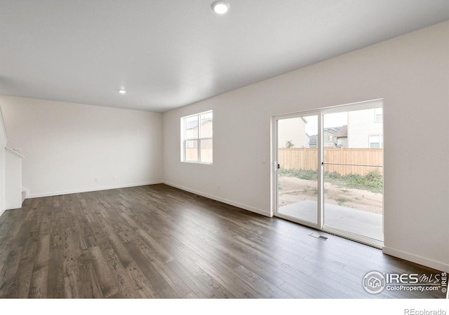 empty room with dark hardwood / wood-style floors