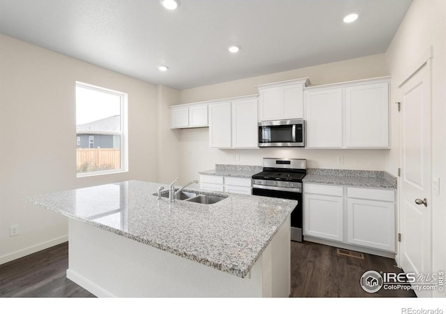 kitchen featuring a center island with sink, sink, white cabinetry, and stainless steel appliances