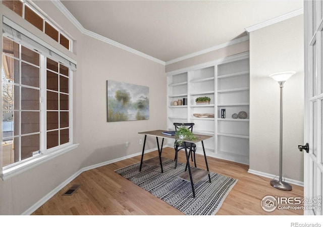 office area featuring light hardwood / wood-style flooring and ornamental molding