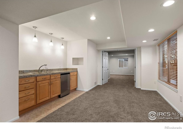 kitchen featuring light tile patterned flooring, decorative light fixtures, stainless steel dishwasher, and sink