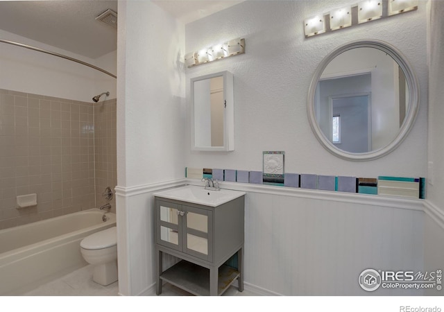 full bathroom with tile patterned flooring, vanity, toilet, and tiled shower / bath