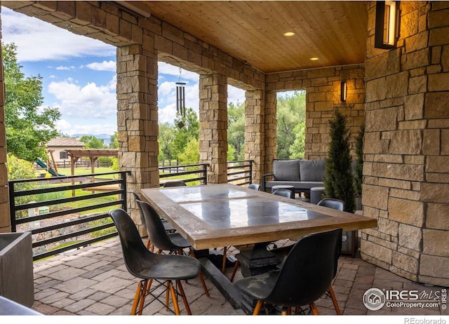 sunroom featuring wooden ceiling