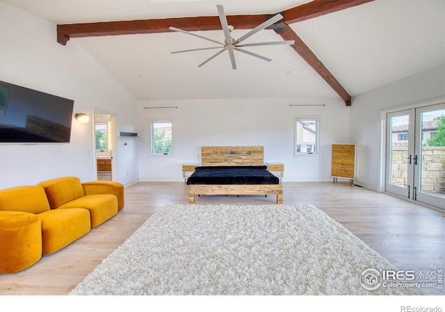 living room with ceiling fan, french doors, beamed ceiling, and light hardwood / wood-style flooring