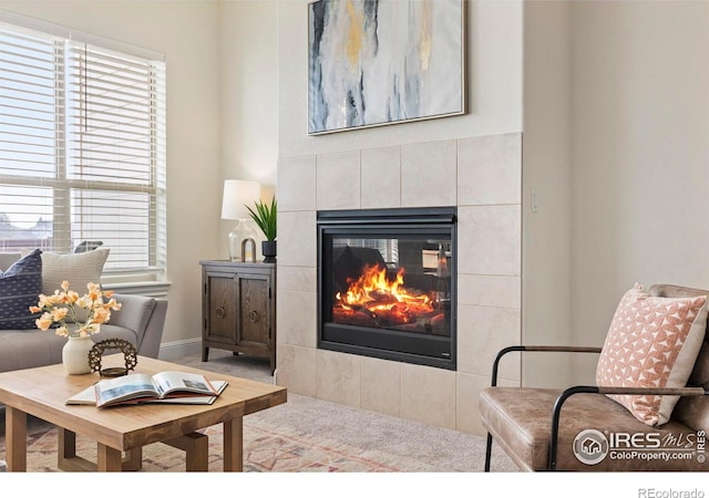 living room with a tiled fireplace