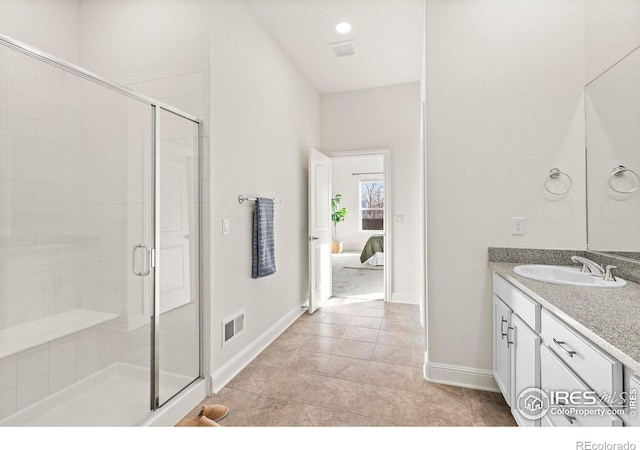 bathroom with tile patterned floors, vanity, and walk in shower