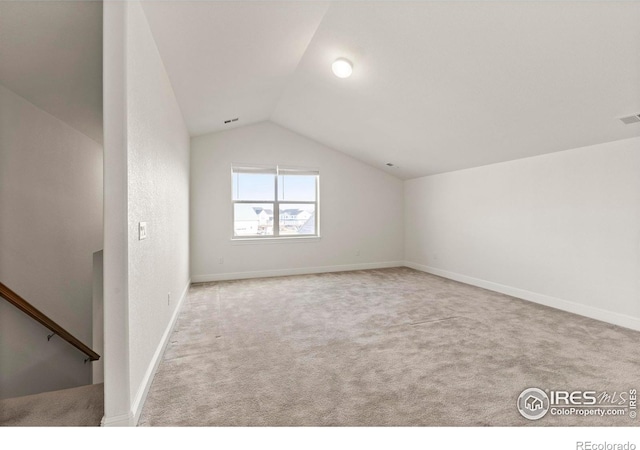 bonus room featuring light colored carpet and lofted ceiling