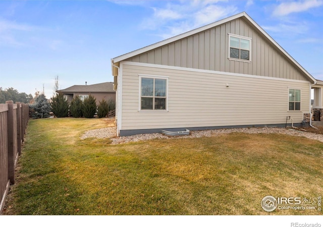 view of side of home with a lawn