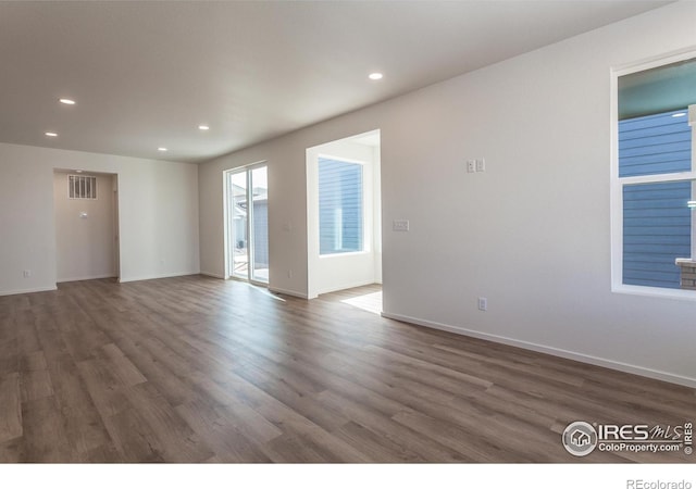 unfurnished room with recessed lighting, visible vents, and wood finished floors