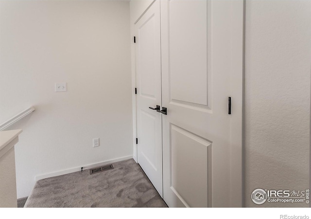 interior space with carpet, visible vents, and baseboards