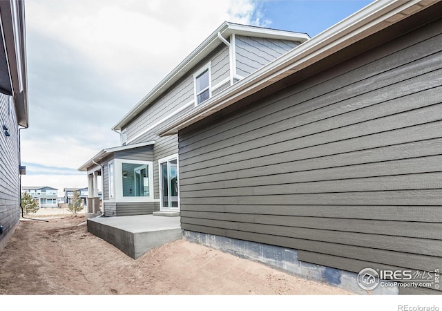 view of property exterior featuring a patio area