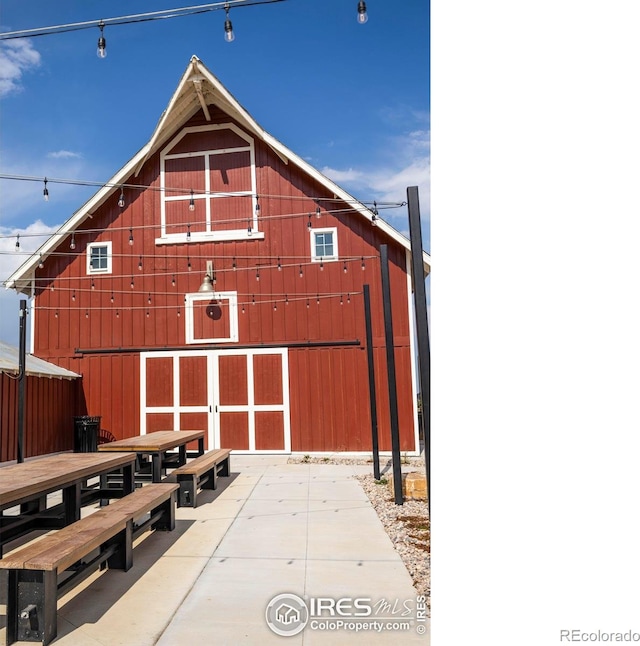 exterior space with a patio area, outdoor dining area, an outdoor structure, and a barn