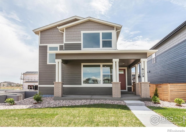 6109 Saddle Horn Dr, Timnath, CO 80547 - craftsman inspired home with a porch and a front lawn