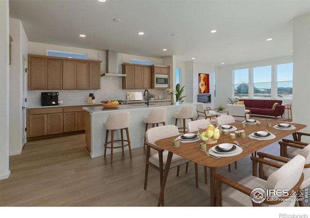 dining area with sink and light hardwood / wood-style flooring