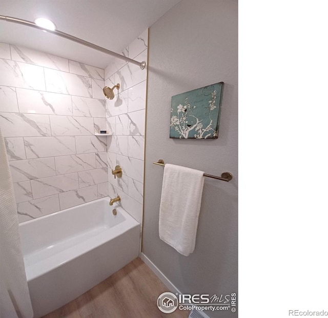 bathroom featuring tiled shower / bath combo and wood-type flooring