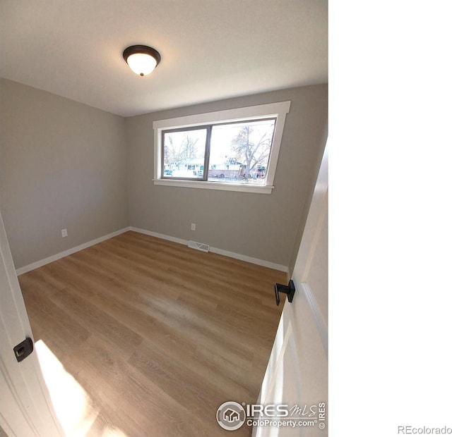 spare room with light wood-type flooring