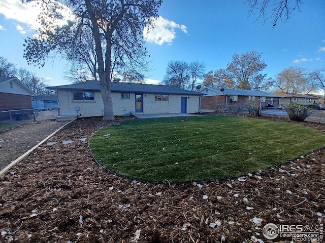 back of property featuring a lawn