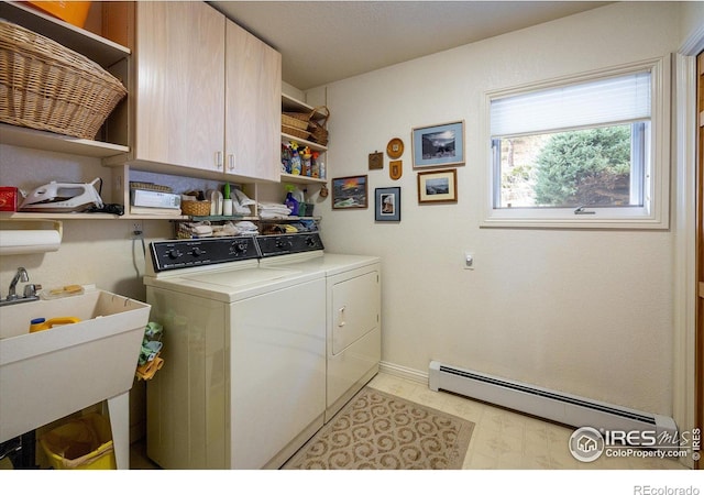 laundry area featuring washer and dryer, cabinets, sink, and a baseboard heating unit