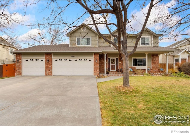 view of front of property with a porch, a garage, and a front yard