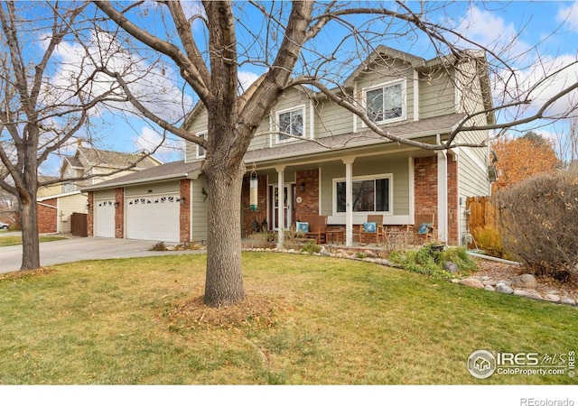 view of front of property with a front lawn, a porch, and a garage