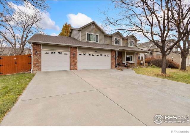 view of front property featuring a garage and a front lawn