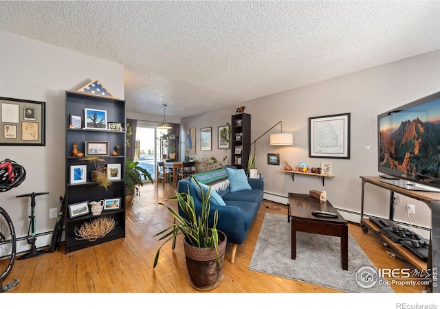 living room with wood-type flooring, a textured ceiling, and a baseboard heating unit