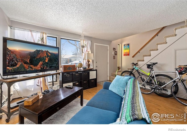 living room with hardwood / wood-style floors and a textured ceiling