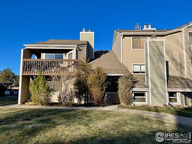 view of front of house with a wooden deck and a front lawn