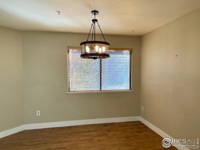 unfurnished dining area featuring dark hardwood / wood-style flooring